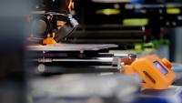 3D printer, photo by Jakub Żerdzicki on Unsplash