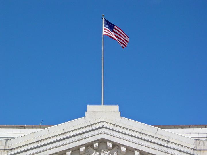 Flag atop the United States Department of the Treasury building, on Pennsylvania Avenue NW in Washington, DC. Photo by Ben Schumin via Flickr, CC-BY-2.0