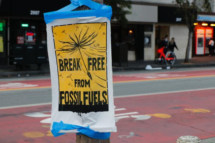 Protest sign 'break free from fossil fuels'. Photo via Unsplash.