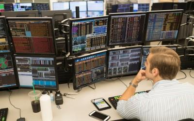 Man staring at multiple data screens